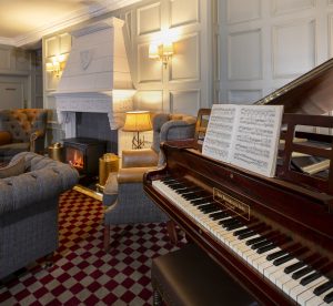 image of a room with a grand piano and fireplace