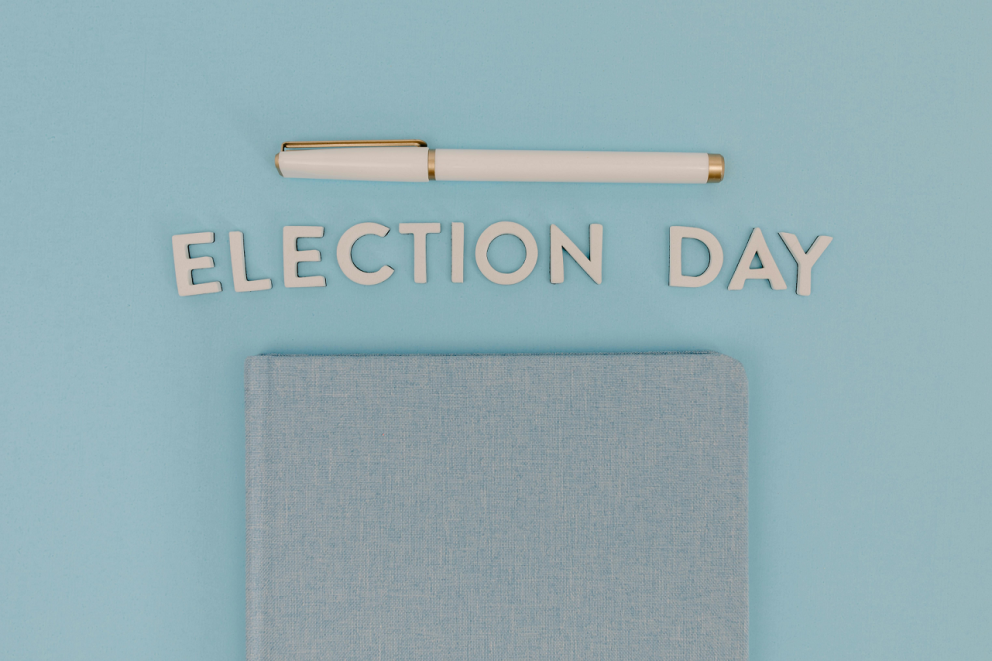 a pen and a note book with the words election day