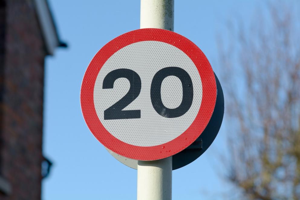 20 miles per hour sign on a pole