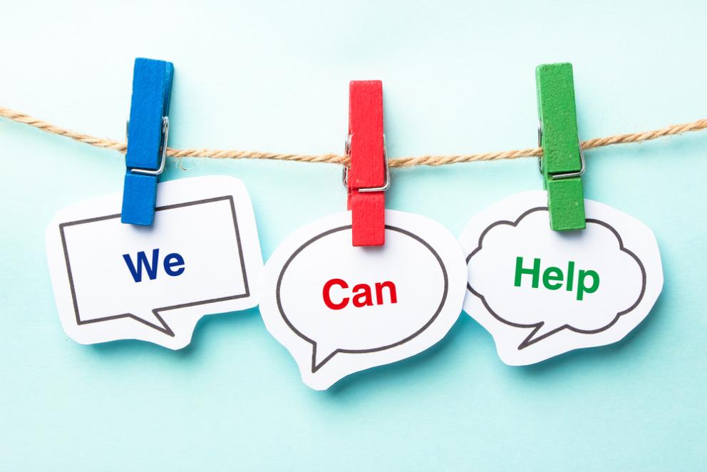 Image shows three pegs on a line holding the words we can help