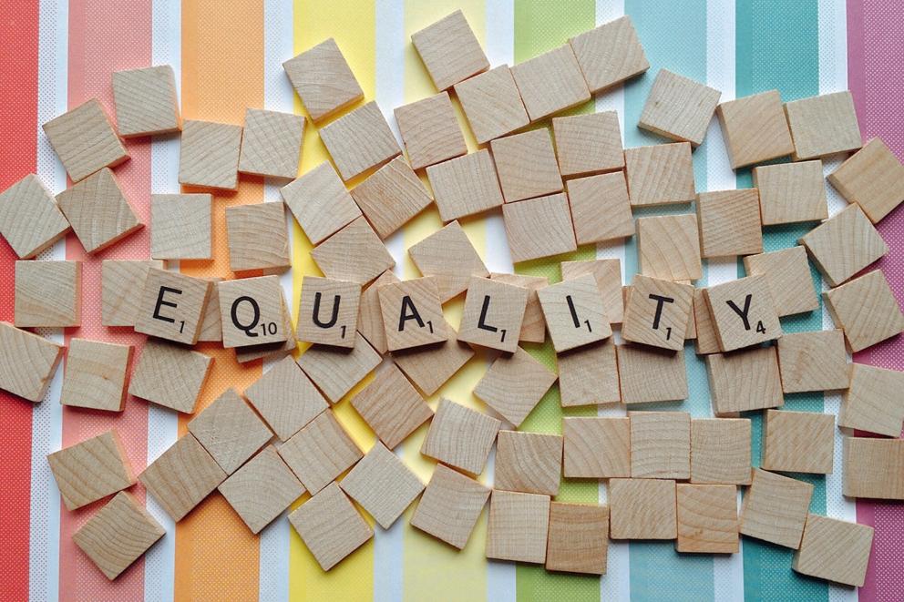 A photograph spelling the word 'equality' using scrabble pieces