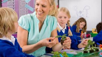 Teacher and pupils learning abut plants