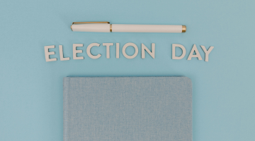 a pen and a note book with the words election day