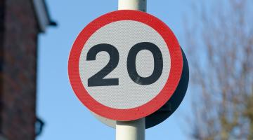 20 miles per hour sign on a pole