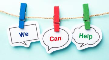 Image shows three pegs on a line holding the words we can help