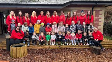 Images shows nursery children and staff pictured outside