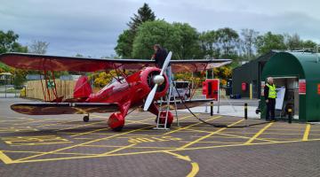 Man filling up plane with fuel