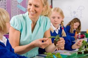 Teacher and pupils learning abut plants