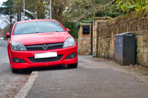 red car parked on a pavement