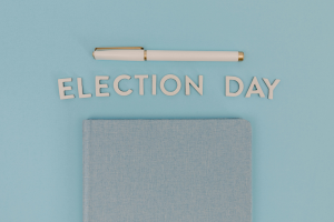 a pen and a note book with the words election day